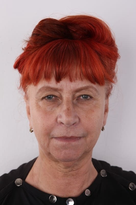 Old redhead with saggy tits gets totally naked before sitting on a stool