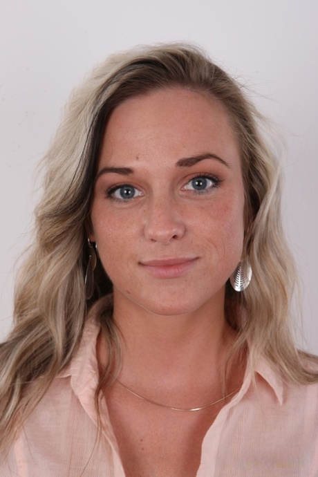 Blonde amateur stands clothed in jeans and a blouse before getting naked