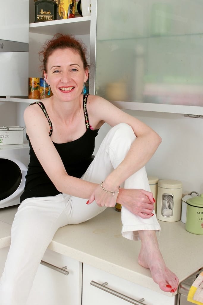 Scarlet A teases her lithe mature frame with a steamy kitchen strip show - 2