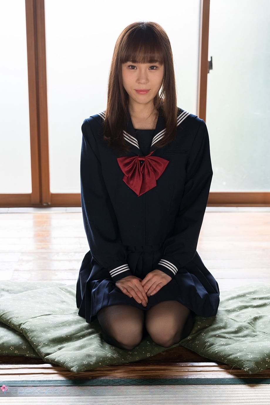 Japanese student releases her slim body from her school outfit on a cushion