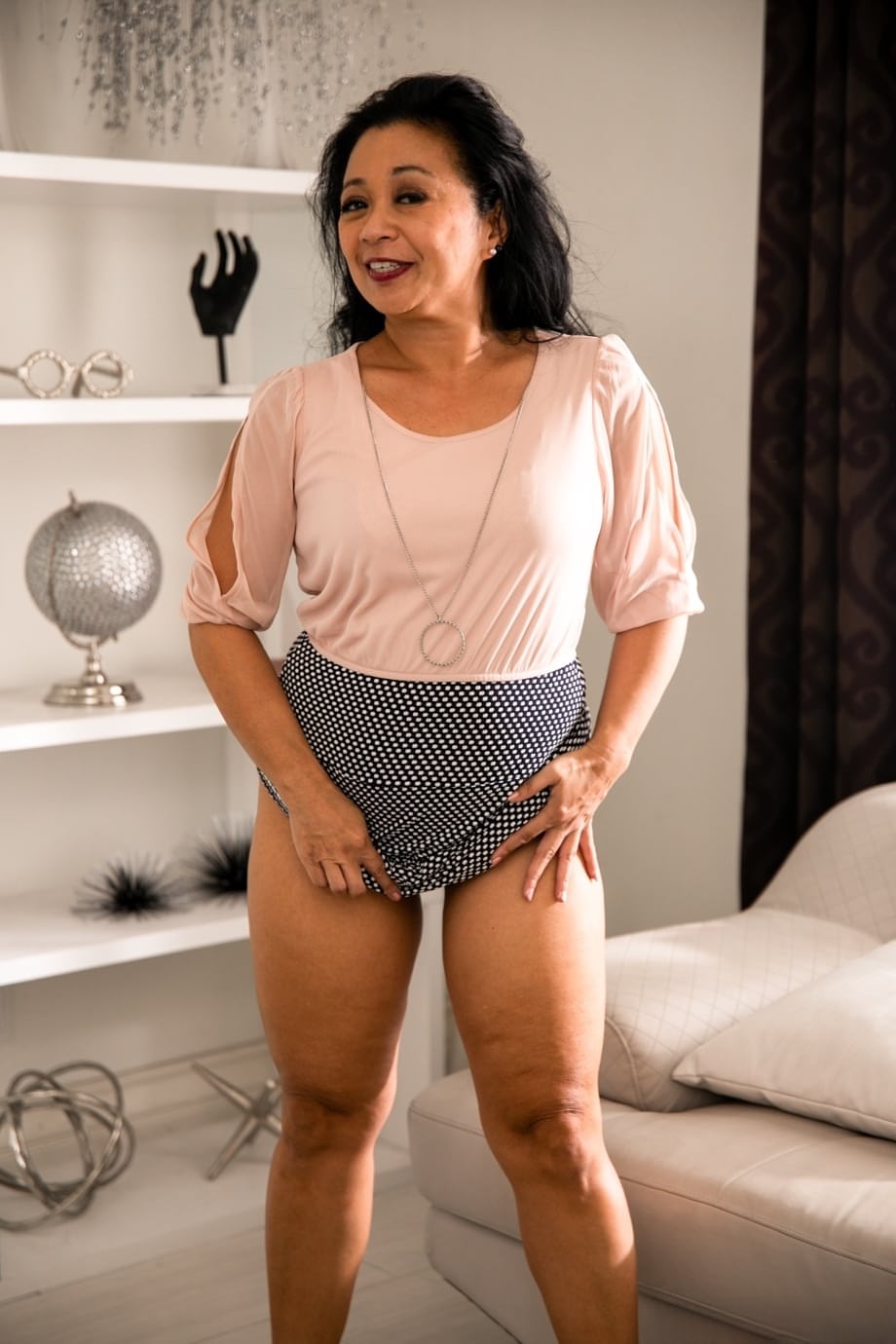 Dark haired cougar Lucky Starr gives her younger lover oral sex