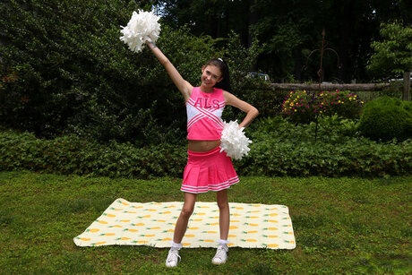 Teen cheerleader Bella Nova aggressively pounding her tight asshole with a huge dildo on her soft blanket - 1