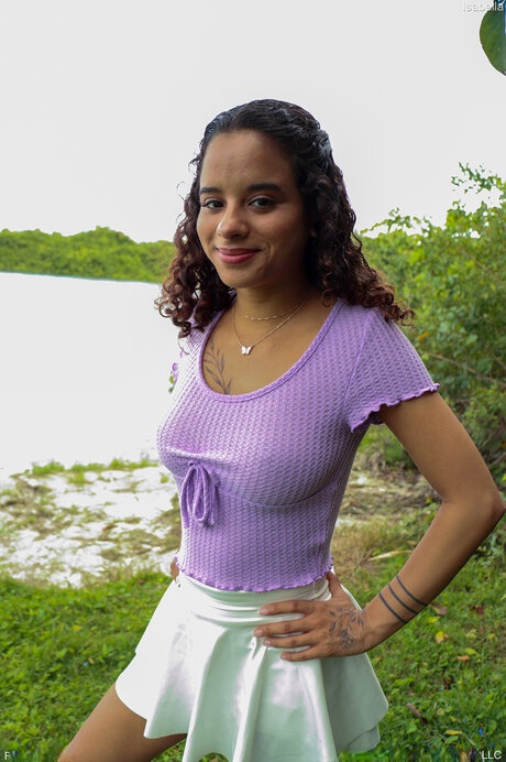 Latina teen shows her fake tits in a white skirt and white sneakers