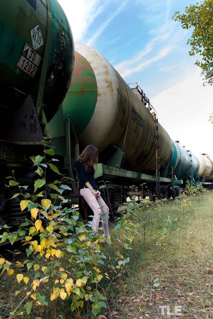 Rebeka Ruby's skinny ass squatting on a rail car, flooding the tracks with golden piss streams - 6