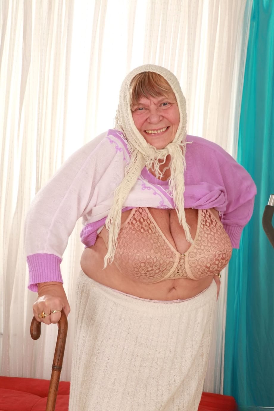 Sara G mature vixen removes top revealing massive boobs in sultry bra - 11