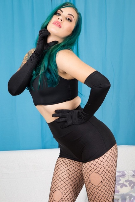 Taurus exposes her flawless curves wearing sleek black velvet gloves with vibrant green hair cascading - 1