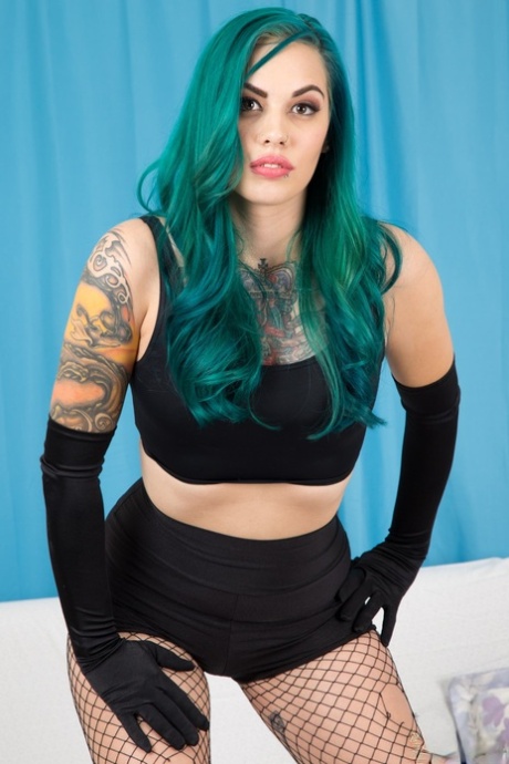 Taurus exposes her flawless curves wearing sleek black velvet gloves with vibrant green hair cascading - 3