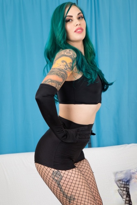 Taurus exposes her flawless curves wearing sleek black velvet gloves with vibrant green hair cascading - 4