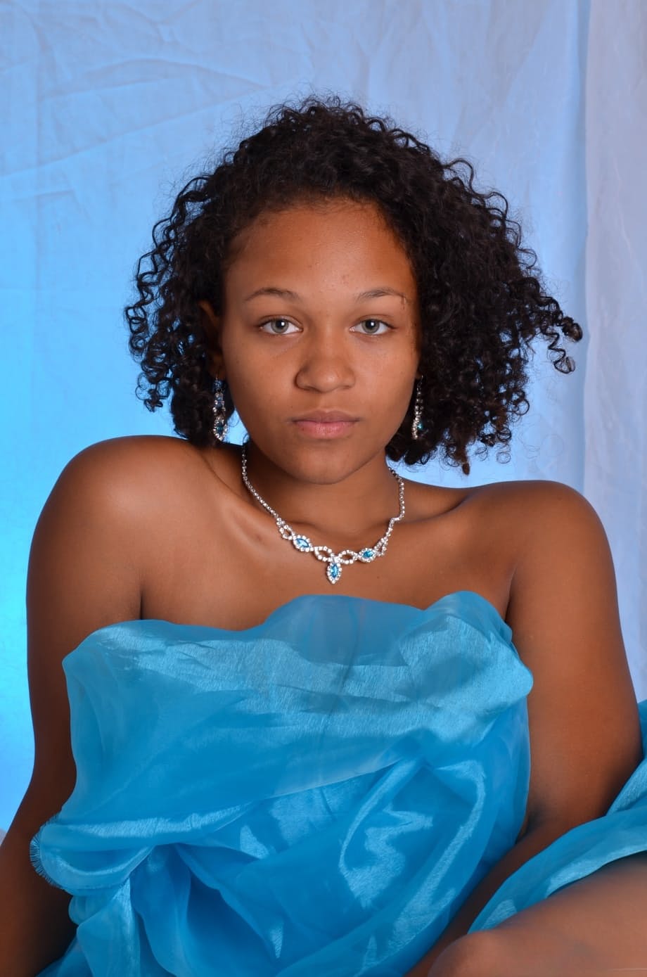 Black first timer models her hair in a teasing manner on a bed