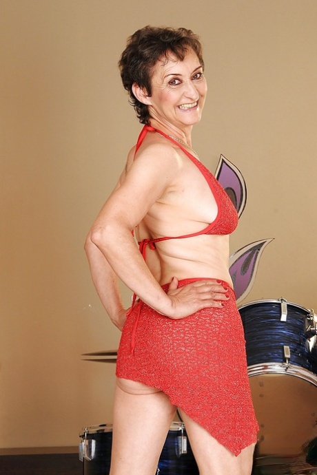 Mature lesbian with a hairy cunt takes off her skirt and panties