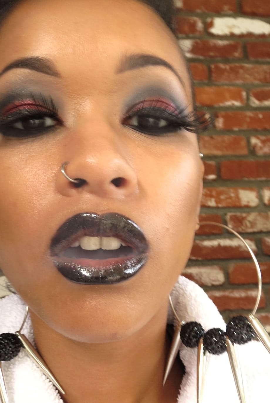 Slender ebony doll Skin Diamond poses in stocking and leather outfit solo