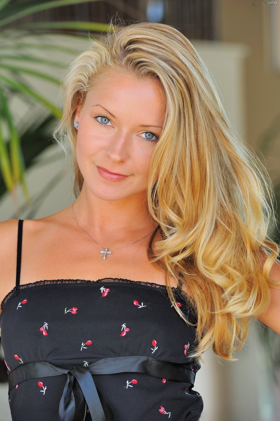 Adorable blonde girl stands naked outdoors after taking off her dress