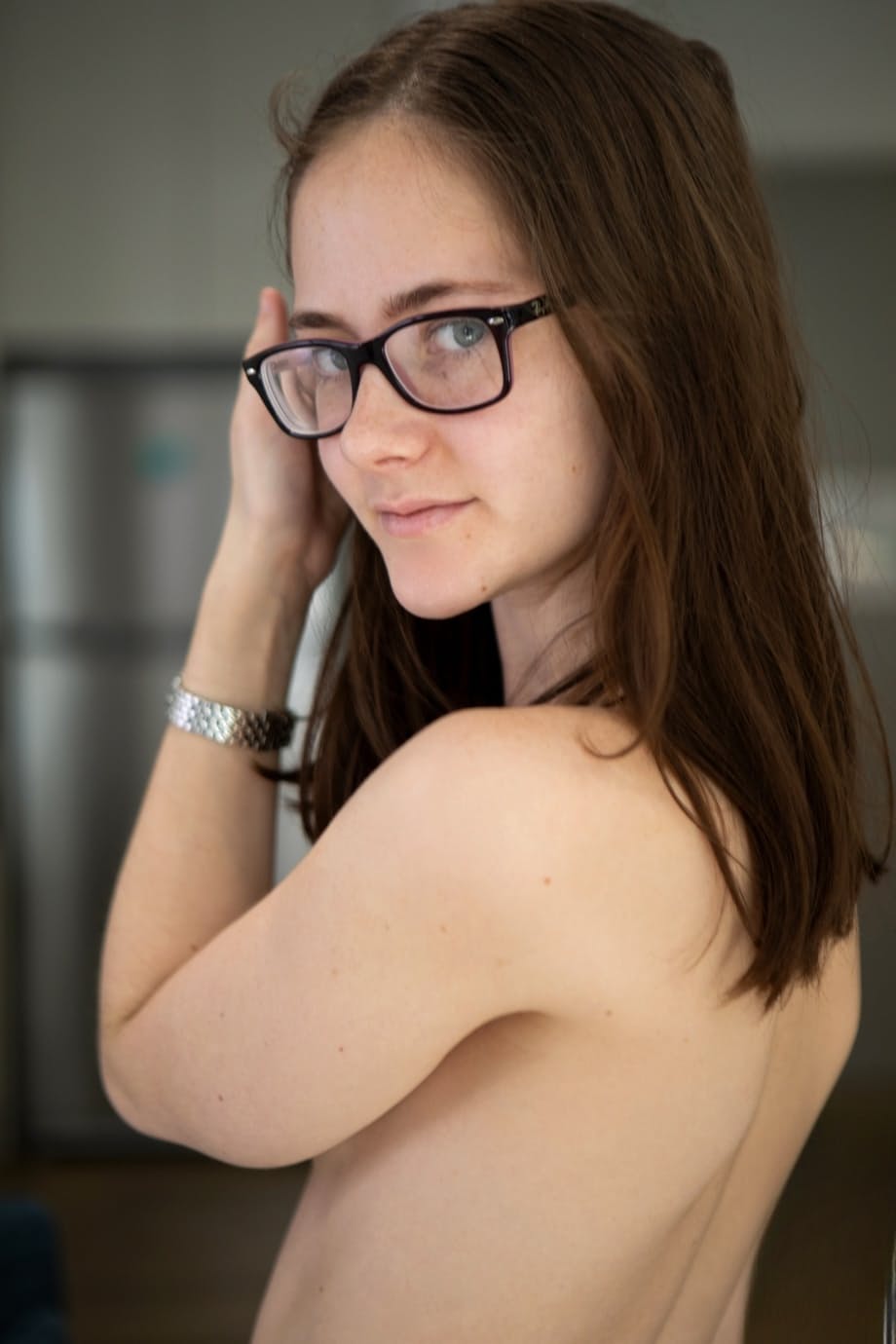 Petite MILF in glasses Eva May strips naked & spreads her inviting hairy pussy