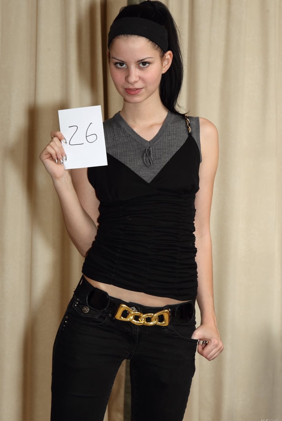 Skinny brunette Judy Smile unveils her small breasts and shaved pussy too