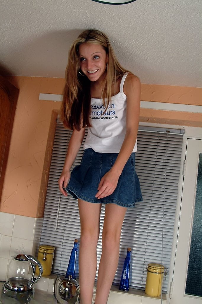 Petite teen Kim B spreading her meaty pussy in a hot kitchen striptease