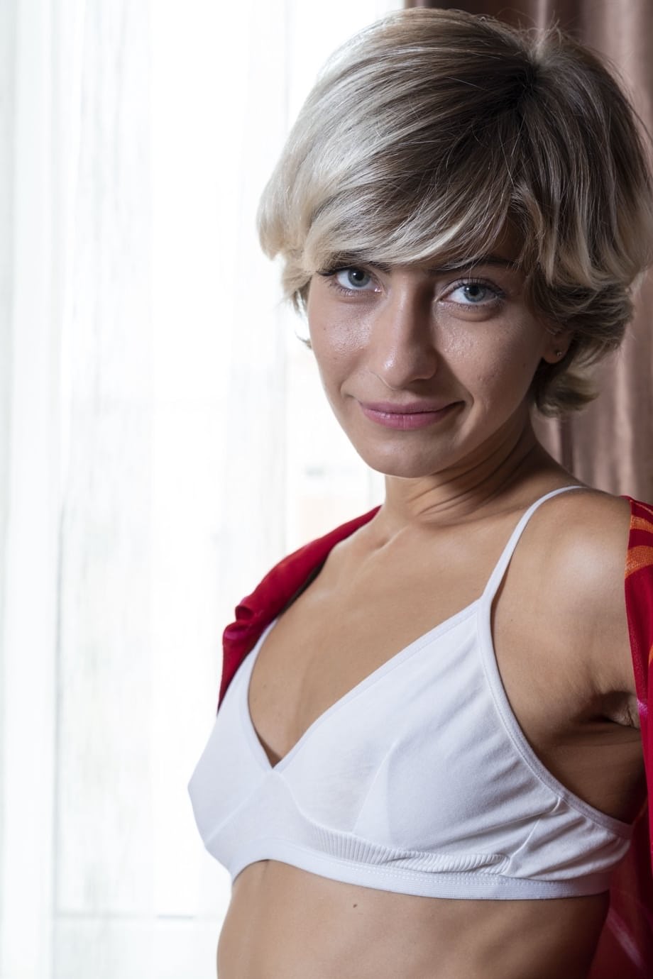 American Laima undresses, spreads her legs and fingers her furry muff