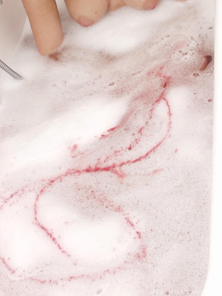 Katalin A undresses and soaks her wet curves in a colorful bath - 3