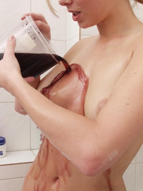 Katalin A undresses and soaks her wet curves in a colorful bath - 7