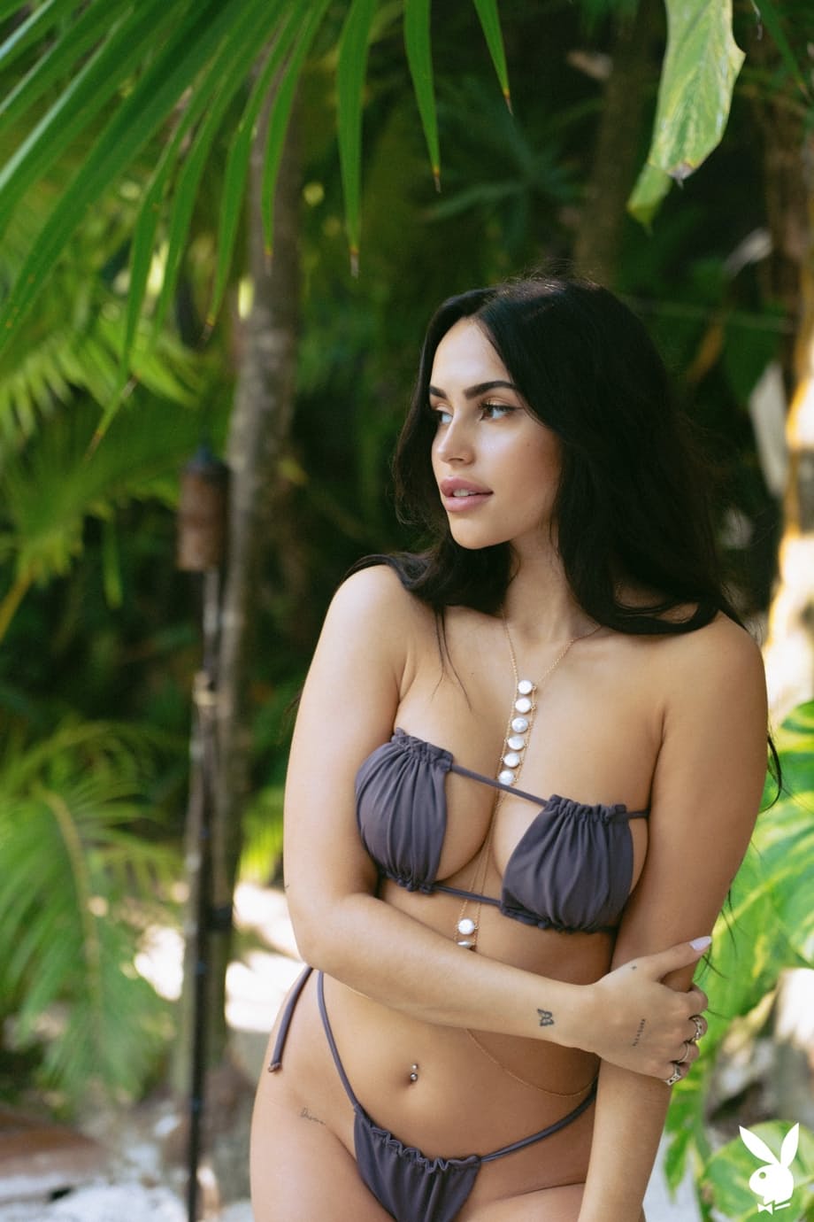 Black haired centerfold Claudia Tihan flaunts her perfect boobs in the pool
