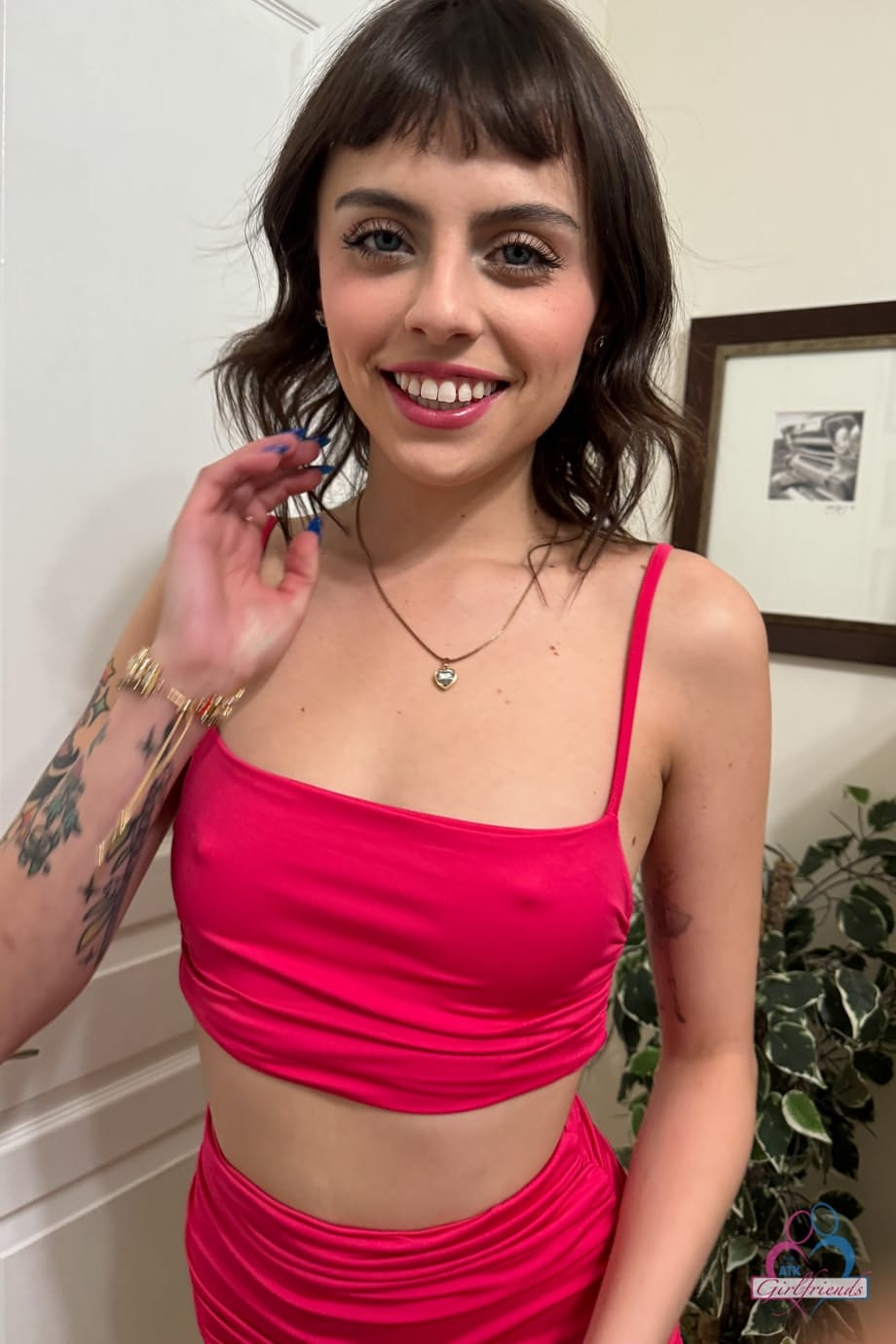 Amateur model Angel Windell strips off her red bikini while indoors