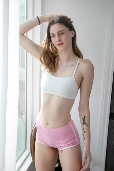 Sexy teen Lilly Jade disrobes on a bed before banging the gardener