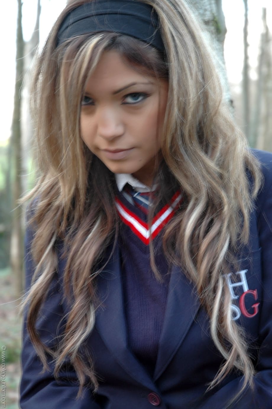 College girl Samantha Buxton is tied to a tree in the woods before undressing