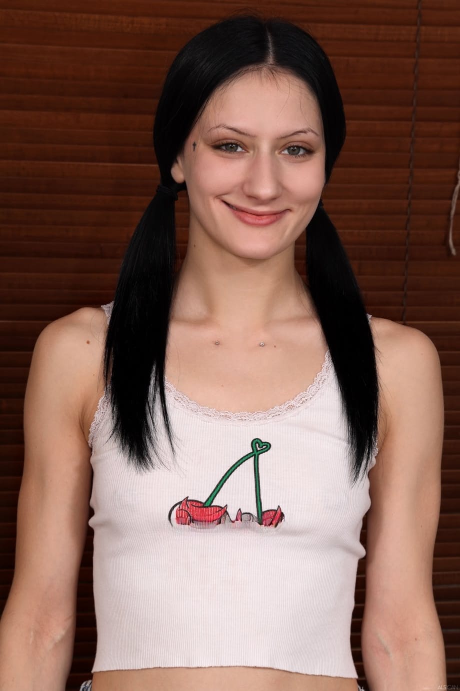 Dark-haired girl stretches out before showing her pink snatch to the camera