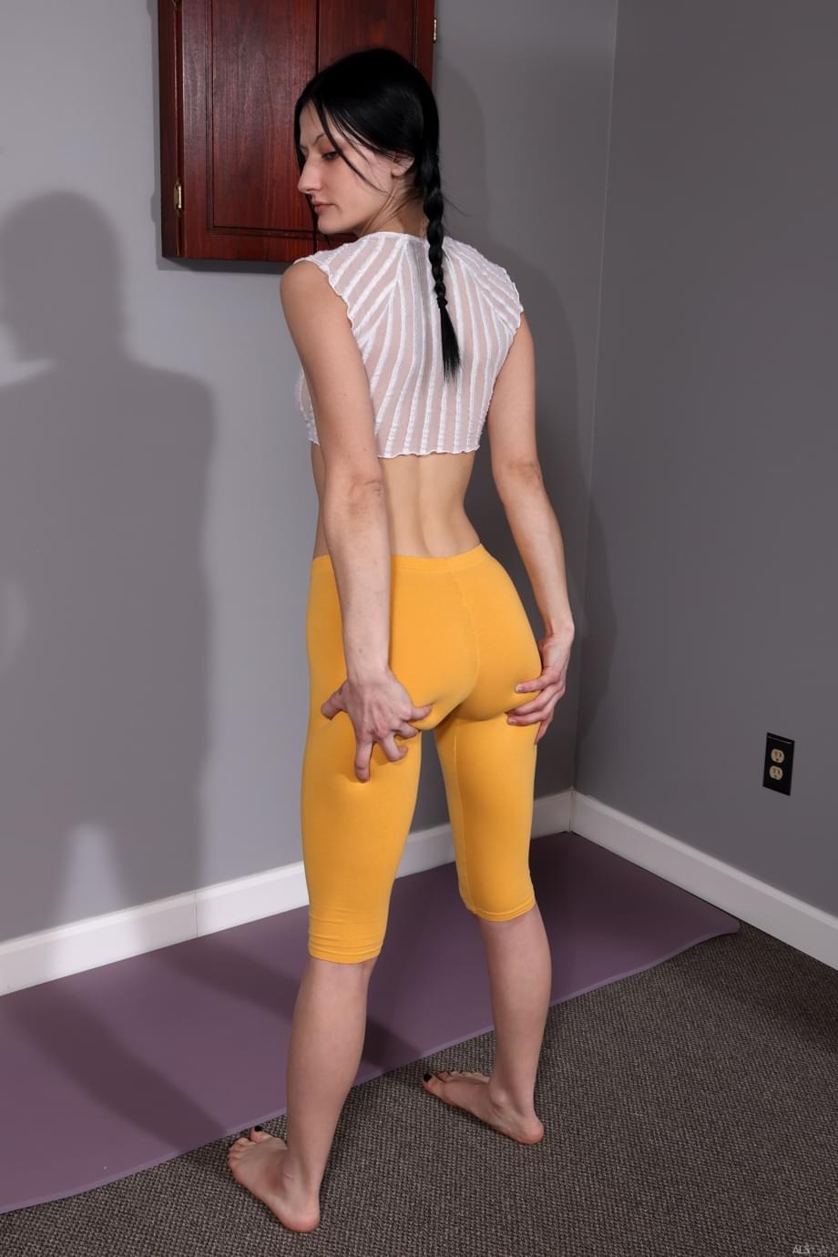 Dark-haired girl masturbates with a baseball bat during a nude session