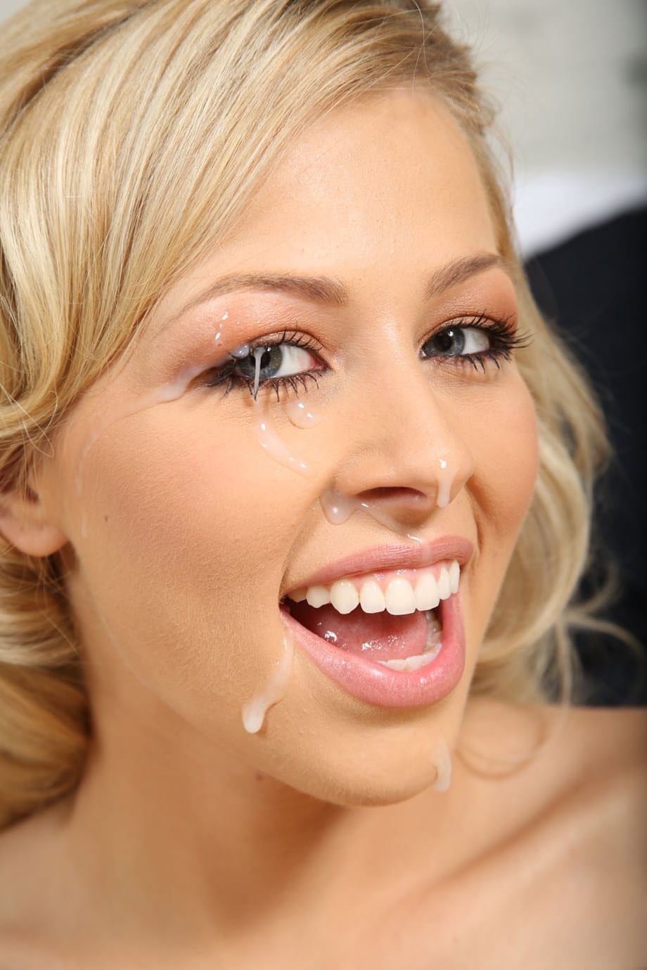 Beautiful blonde Zoey Monroe takes a facial while giving a POV handjob