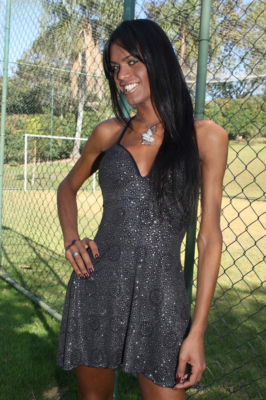 Latina shemale Kawanna di Prado holds her erection after getting naked