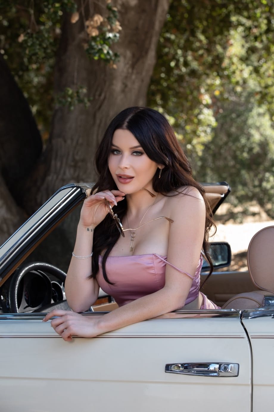 Hot brunette Renee Olstead gets naked on the hood of a car near the woods