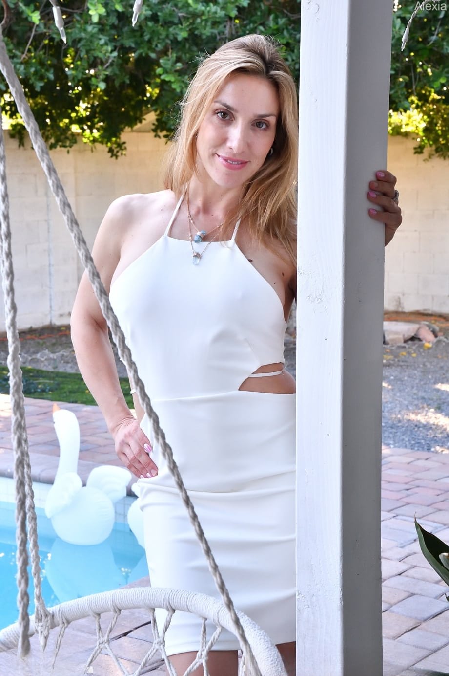 Alexia strips naked outdoors, fingering her dripping pussy in her shiny white boots - 7
