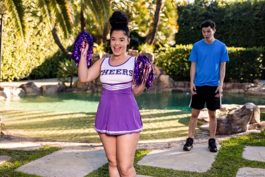 Archer Ali offers oral pleasure to a throbbing cock in sultry cheerleader attire outdoors - 10