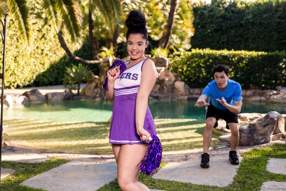 Archer Ali offers oral pleasure to a throbbing cock in sultry cheerleader attire outdoors - 11