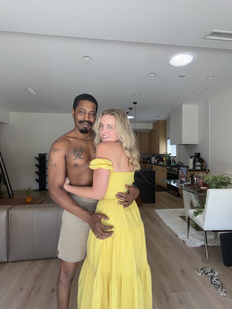 Charlie Forde strikes enticing solo poses on bed in sheer yellow dress - 2