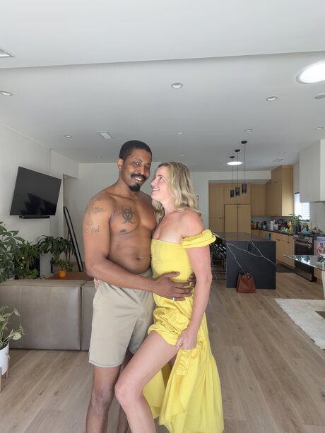 Charlie Forde strikes enticing solo poses on bed in sheer yellow dress - 3