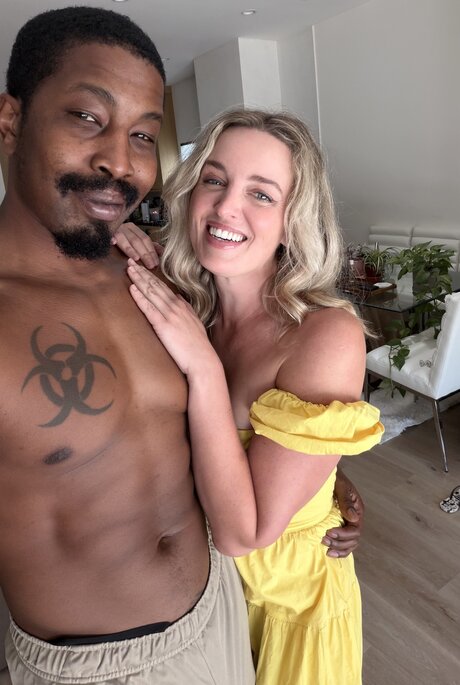 Charlie Forde strikes enticing solo poses on bed in sheer yellow dress - 5