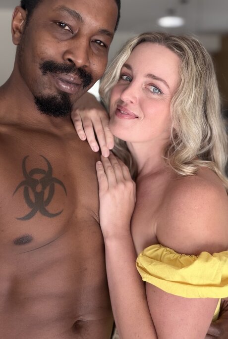 Charlie Forde strikes enticing solo poses on bed in sheer yellow dress - 7